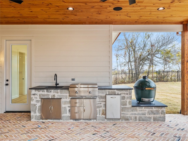 view of patio with a grill, sink, and an outdoor kitchen