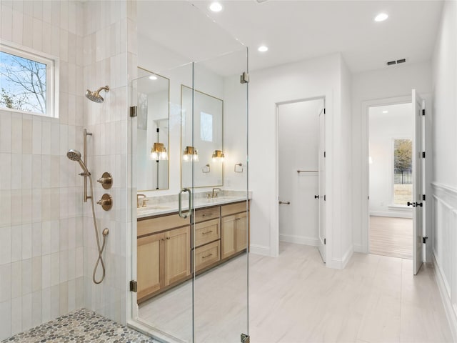 bathroom featuring vanity and tiled shower