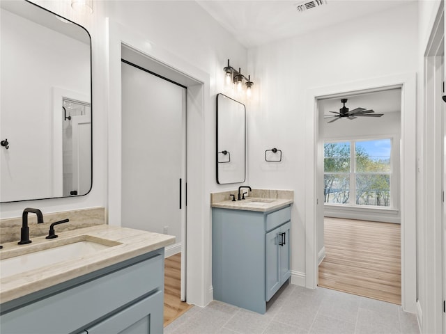 bathroom featuring hardwood / wood-style floors, vanity, and ceiling fan