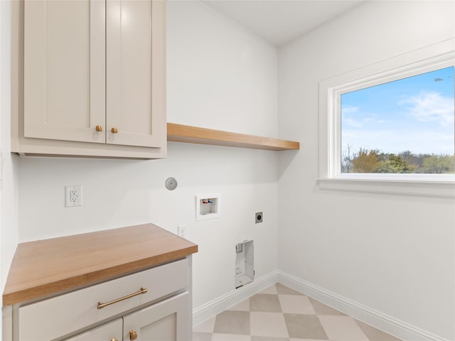 laundry area featuring hookup for an electric dryer, hookup for a washing machine, gas dryer hookup, and cabinets