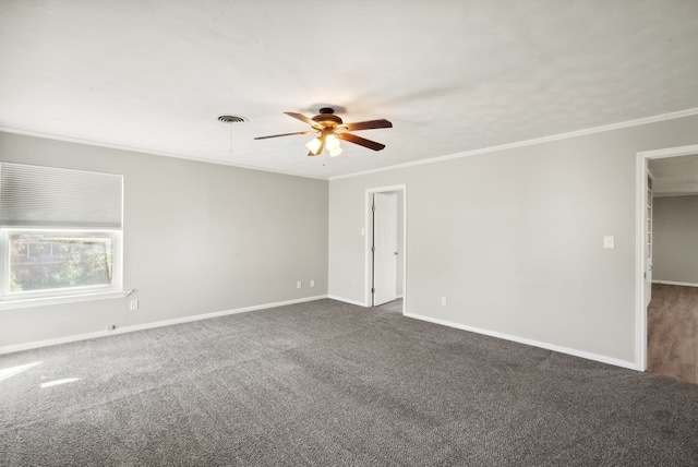 spare room with dark carpet, crown molding, and ceiling fan