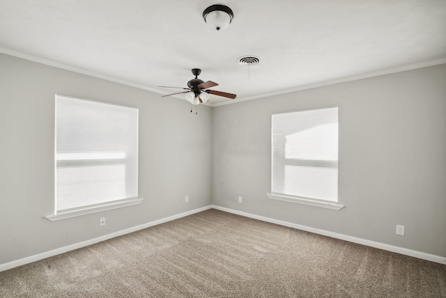 carpeted spare room with ornamental molding and ceiling fan