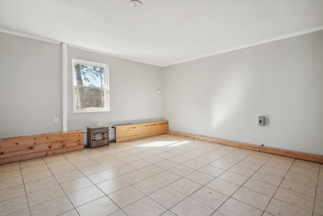 tiled empty room featuring crown molding