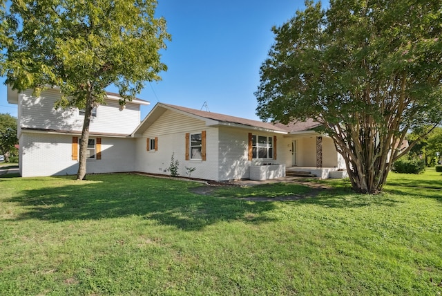 back of property featuring central AC unit and a yard