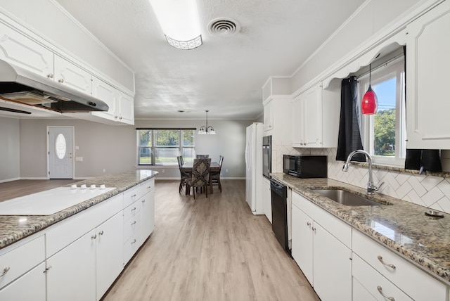 kitchen featuring white cabinets, pendant lighting, sink, backsplash, and black appliances