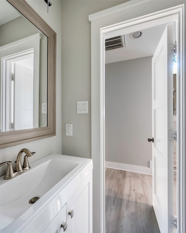 bathroom featuring vanity and hardwood / wood-style floors