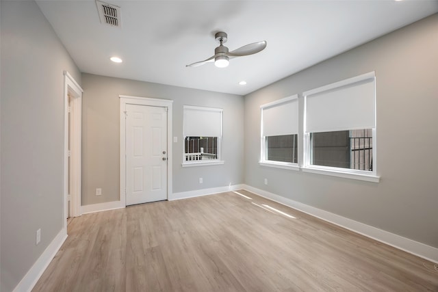 unfurnished bedroom with ceiling fan and light wood-type flooring