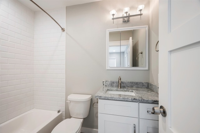 full bathroom featuring vanity, tiled shower / bath combo, and toilet