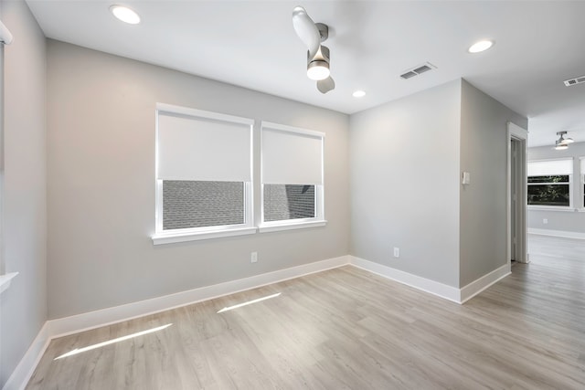 unfurnished room with ceiling fan and light wood-type flooring