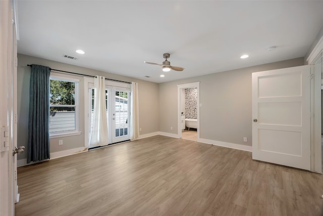 empty room featuring ceiling fan and light wood-type flooring