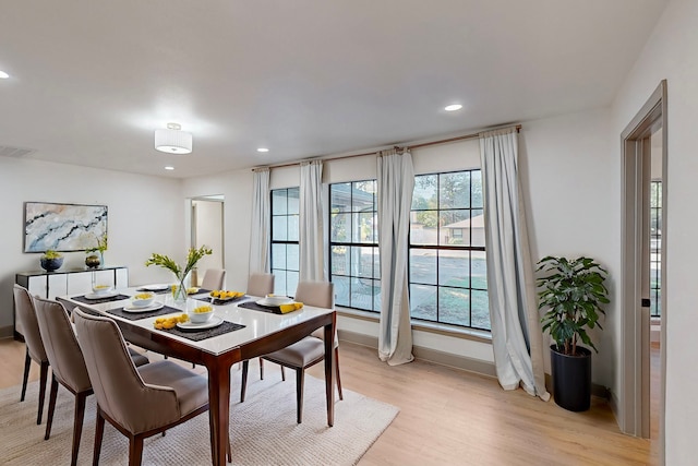 dining space with light wood-type flooring