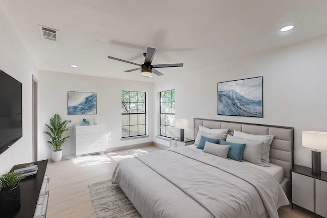 bedroom with light hardwood / wood-style floors and ceiling fan