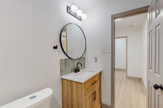 bathroom with vanity, hardwood / wood-style floors, and toilet