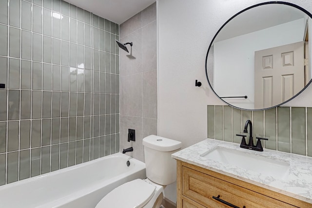 full bathroom featuring tiled shower / bath combo, decorative backsplash, vanity, and toilet