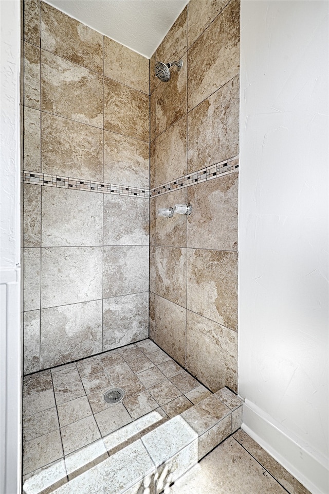 bathroom with a tile shower