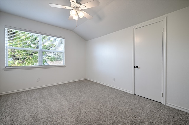 interior space with ceiling fan, vaulted ceiling, and carpet