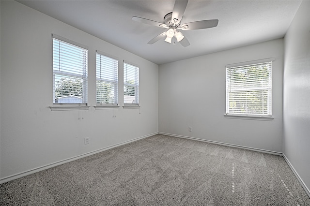 carpeted empty room featuring ceiling fan