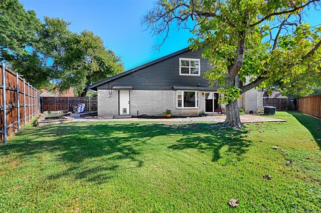 back of property featuring a patio, central air condition unit, and a yard