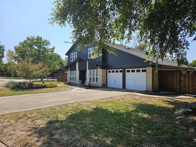 view of front of property featuring a front lawn and a garage