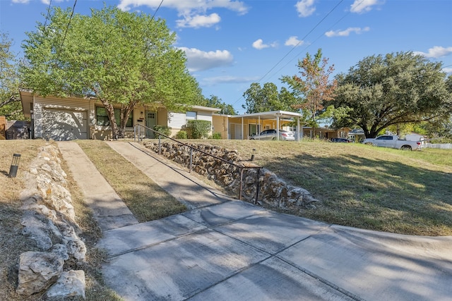 single story home with a garage and a front lawn