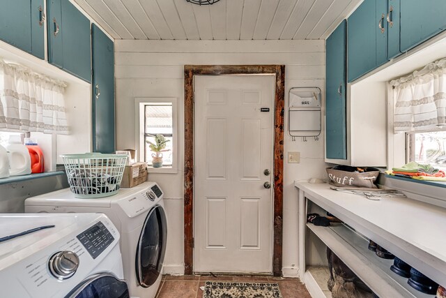 laundry area featuring wooden ceiling, washing machine and dryer, wood walls, and laundry area