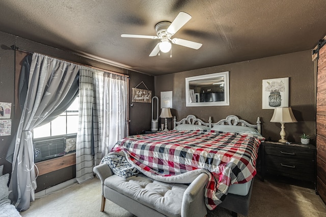 carpeted bedroom with a textured ceiling and ceiling fan