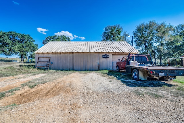 view of property exterior with an outdoor structure