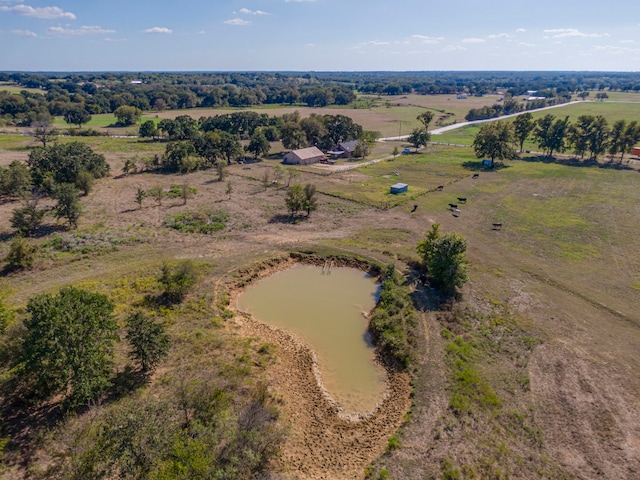 birds eye view of property with a water view and a rural view