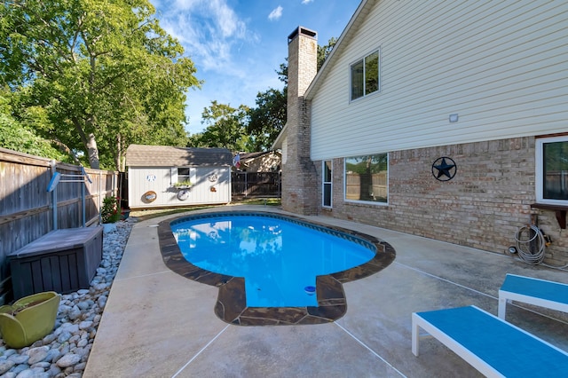 view of pool with a storage unit and a patio area