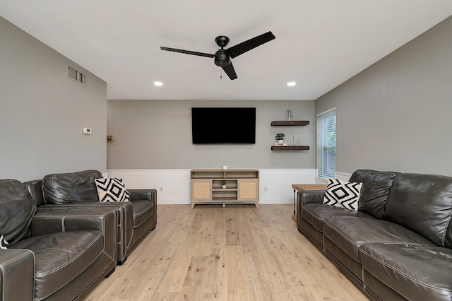 living room featuring light hardwood / wood-style floors and ceiling fan