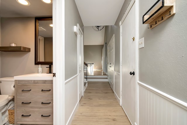 corridor with light hardwood / wood-style floors