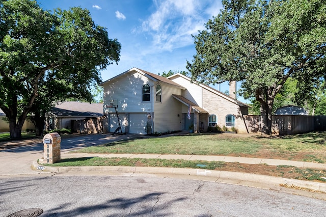 view of front of home with a garage and a front lawn