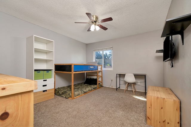 bedroom featuring a textured ceiling, carpet flooring, and ceiling fan