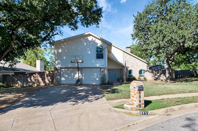 view of front of house with a garage and a front lawn