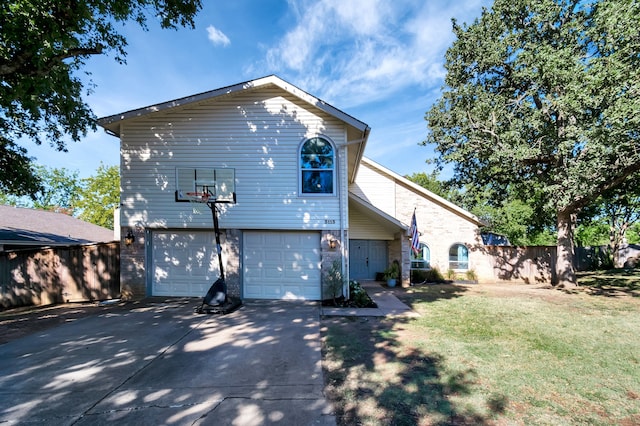 back of house featuring a yard and a garage