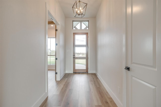 hall featuring hardwood / wood-style floors and a notable chandelier