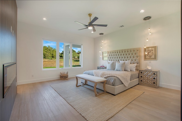 bedroom with light hardwood / wood-style floors and ceiling fan