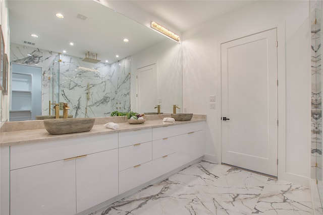 bathroom with vanity and a shower with door