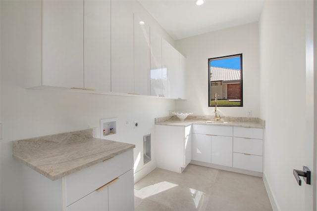 laundry room featuring cabinets, electric dryer hookup, hookup for a washing machine, and sink