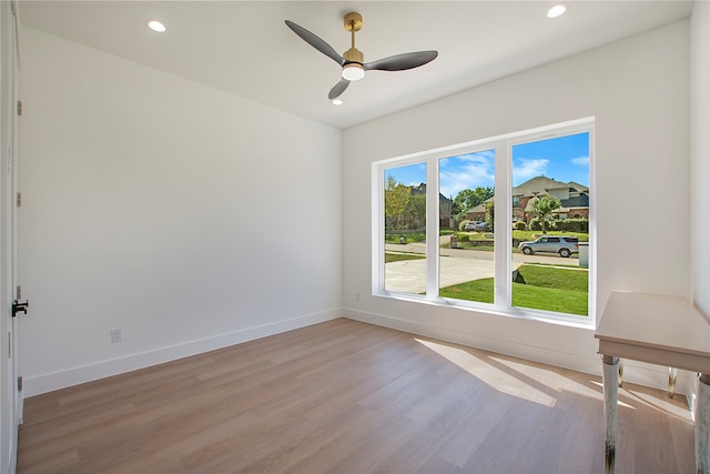 spare room featuring light hardwood / wood-style flooring and ceiling fan