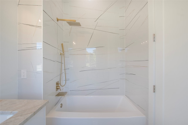 bathroom with vanity and tiled shower / bath