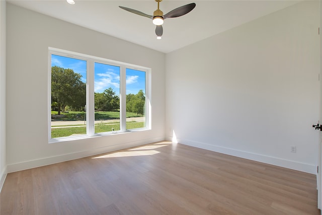 unfurnished room with ceiling fan and light wood-type flooring