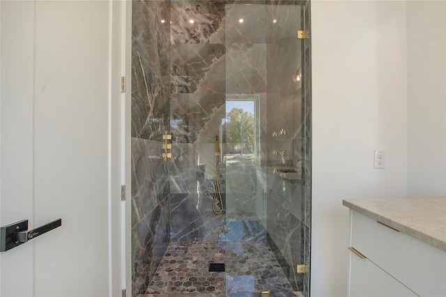 bathroom with vanity and a shower with shower door