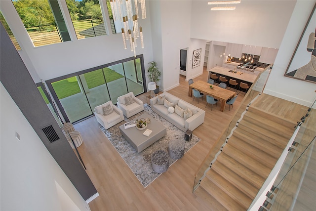 living room with a high ceiling and hardwood / wood-style floors