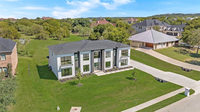 view of front of property featuring a front lawn and a garage