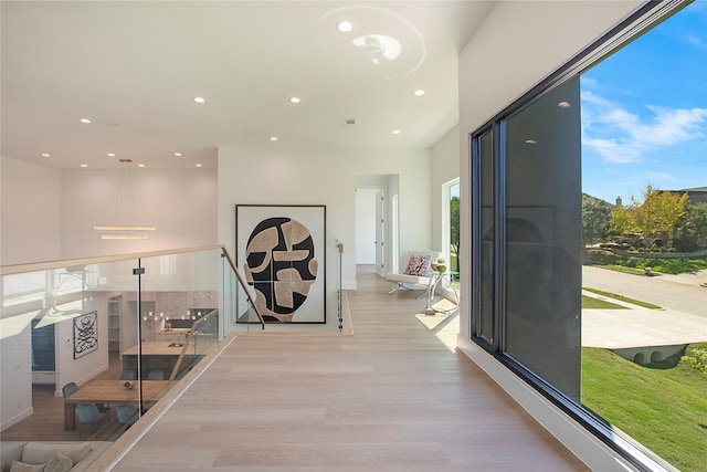 hallway with light hardwood / wood-style flooring