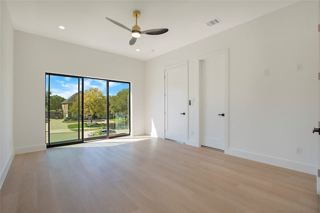 empty room with light wood-type flooring and ceiling fan