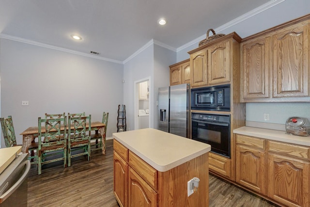 kitchen with ornamental molding, black appliances, a kitchen island, and dark hardwood / wood-style flooring