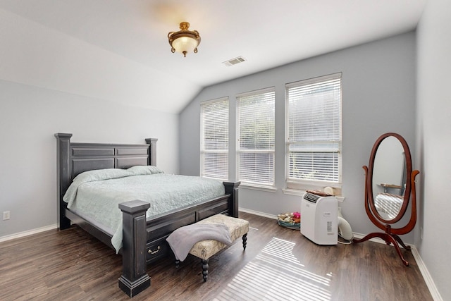 bedroom with lofted ceiling and dark hardwood / wood-style floors