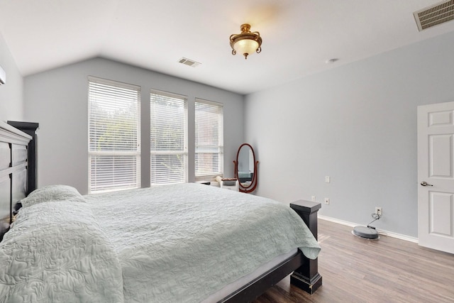 bedroom featuring wood-type flooring and vaulted ceiling